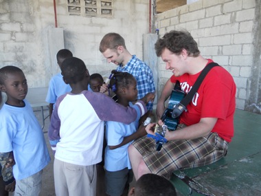 Teaching guitar to kids on the eighth day at an after school program.